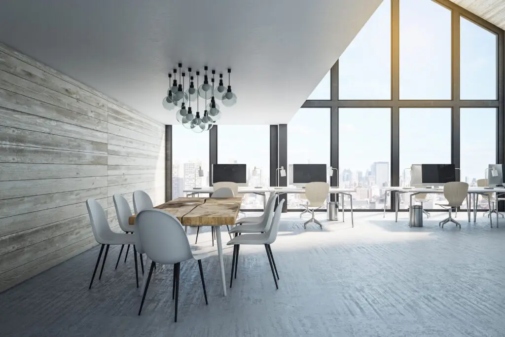 Minimalistic coworking office interior with computers, wooden wall and panoramic city view. Workplace and company concept.