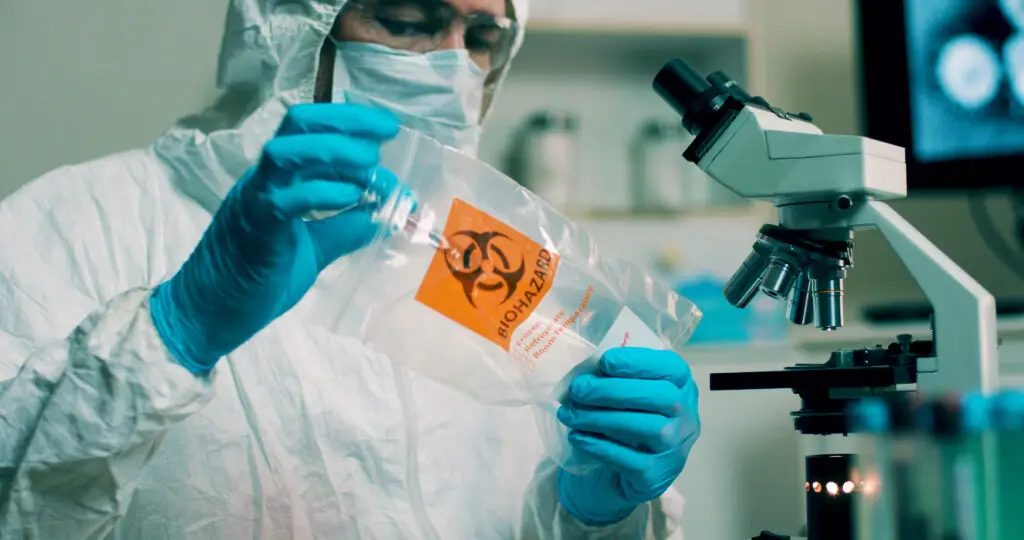 medium shot lab tech with sample of virus.